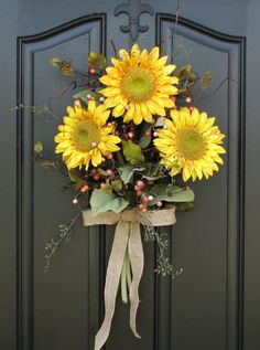 a bouquet of sunflowers tied to a front door