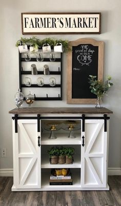 a white buffet table with shelves and plants on top