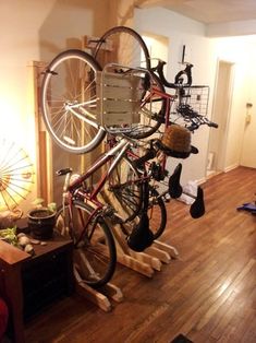 a bicycle is mounted to the side of a wall in a room with wood floors