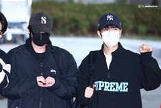 two young men wearing masks while standing next to each other