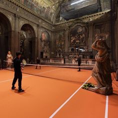 a little boy standing on top of a tennis court