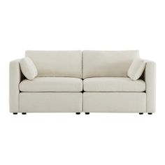 a white couch with two pillows on it