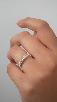 a woman's hand with a diamond ring on it