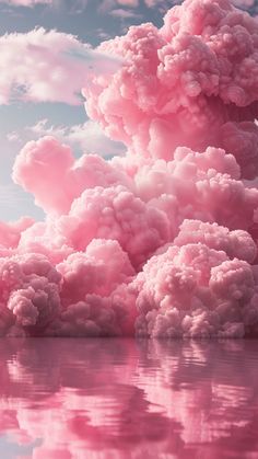 pink clouds floating in the sky over water