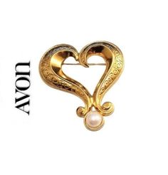 Avon extra large heart pin brooch vintage gold tone scroll engraved metal finish swirl wide fancy band round domed white end pearl bead. Signed Avon on the back of the pin brooch. In excellent vintage condition. Measures 3 1/8 inches long 2 5/8 inches wide. Elegant Brooch For Valentine's Day, Elegant Valentine's Day Brooch Jewelry, Elegant Valentine's Day Brooch, Elegant Gold Brooch For Valentine's Day, Elegant Gold Brooches For Valentine's Day, Scroll Engraving, Monet Earrings, Engraved Metal, Pearl Heart