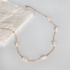 Add some glamour to your style with this exquisite gold-filled and natural pearl pattern necklace. Whether you're dressing up or dressing down, this luxurious piece will always make you look your best. Beautify your jewelry box with this classic staple. Gold Filled Pearl Pattern Necklace Details: Hypoallergenic, Tarnish-Free, Sweatproof, Waterproof Metal: 14K Gold-Filled Chain Length: 45cm Perfect your Parure by pairing with our Pearl with Gold Halo Studs and our Classic Chain Link Bracelet. Genuine Pearl Necklace, Dainty Necklaces, Pearl Chain Necklace, Gold Pearl Necklace, Pearl Choker Necklace, Freshwater Pearl Necklace, Trendy Necklaces, Pearl Choker, Handmade Gold