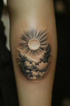 a woman's leg with a sun and clouds tattoo on it