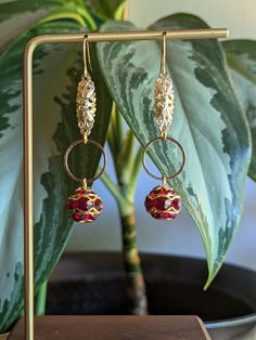 "Redesigned vintage red crystal & gold dangly earrings. Gorgeous dark red crystals with gold details.  Originally clip-on earrings, this set has been repurposed & recreated into a fun new style for pierced ears. New hardware, new bits & pieces, new look. *Note: as parts of the earrings are sourced from vintage materials there is some slight wear, but that's what makes them special (: No two sets of earrings will be the same.  ------ Hooks shown are 14k gold-plated fish hook-style hooks, but can Dark Red Crystals, Dangly Earrings, Red Crystals, Pierced Ears, Gold Details, Fish Hook, New Style, Dark Red, Long Tops