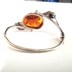 antique design silver cuff bracelet with natural amber Vintage Baltic Amber Jewelry For Formal Occasions, Vintage Amber Bangle Jewelry, Silver Baltic Amber Oval Jewelry, Silver Oval Baltic Amber Jewelry, Elegant Oval Amber Bracelets, Elegant Amber Bangle Jewelry, Adjustable Amber Bangle Jewelry, Elegant Amber Bangle Bracelet, Adjustable Amber Bracelet For Formal Occasions