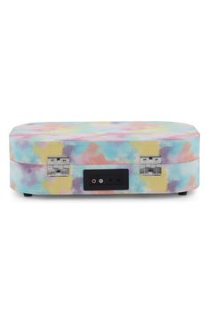 a multicolored suitcase sitting on top of a white surface