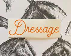 a piece of paper with the word dressage on it next to a drawing of horses