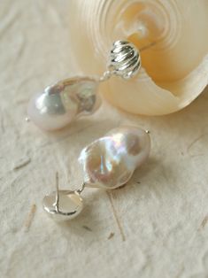 Discover the hidden allure of our exclusive "Undercurrent" collection featuring Baroque Pearl Earrings! Each piece is a unique masterpiece, combining intricately carved silver-tone shell metal fittings with natural, irregular Baroque pearls. The result is a cool, sophisticated elegance that stands out. Embrace the luxury of individuality with these one-of-a-kind treasures! Metal: Recycled Sterling Silver Plated On Brass/925 Sterling Silver Ear Needle Pearl: Natural Baroque Pearls Earrings Dimensions: Length 40mm Single Weight: 6-8g Pearls Earrings, Baroque Pearl Earrings, Tiger Eye Stone, Stunning Earrings, Recycled Sterling Silver, Pearl Drop Earrings, Pearl Drop, Baroque Pearls, Unique Earrings