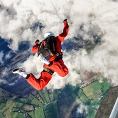 a man flying through the air on top of a snow covered ski slope with his feet in the air