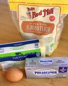 eggs, butter, and other ingredients are sitting on a wooden countertop next to a bag of red mill flour