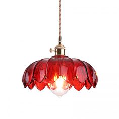 a red glass light hanging from a ceiling