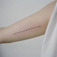 a woman's arm with a quote on it