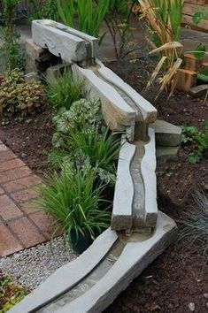 a stone bench sitting in the middle of a garden