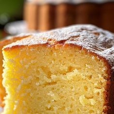 a piece of cake sitting on top of a white plate covered in powdered sugar