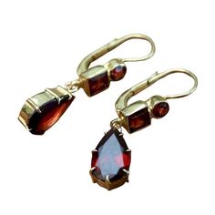 Sensual minimalism. A trio of faceted garnets reflect all the colors of the ballroom. Hand crafted of 24k gold over sterling silver, with European backs for pierced ears. Size: 1 1/4 inches. Duchess Of Kent, Laurel Burch, Garnet Earrings, Knot Earrings, Rhodolite Garnet, Moonstone Necklace, Hand Made Jewelry, Gold Plated Earrings, Gorgeous Earrings