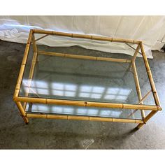 a bamboo and glass coffee table on concrete floor