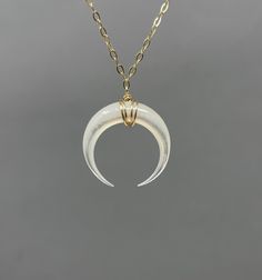 White Mother of Pearl double horn is wrapped in 14k gold fill, 14k rose gold fill, or sterling silver wire and hangs on a 14k goldfill, 14k rose gold fill, or sterling silver chain. The pendant measures 3/4ths of an inch in width. You can choose the length you want when you checkout. If you want a size smaller than 16 inches, let me know when you checkout. You can make the necklace adjustable by adding an extension chain to your cart: https://www.etsy.com/listing/182425506/add-on-extension-chain Minimalist White Crescent Jewelry, Unique White Crescent Jewelry, Unique Crescent Shaped White Jewelry, Gold Crescent Wire Wrapped Jewelry, Gold Crescent Moonstone Necklace, Scorpio Jewelry Necklaces, Moon-shaped Brass Necklace For Gift, Engraved Moon-shaped Brass Necklace, Crescent Horn Necklace