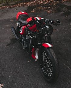 a red and white motorcycle parked in a parking lot