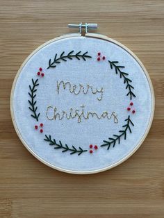 a white embroidery hoop with merry christmas written on it