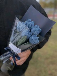 a person holding a bouquet of flowers in their hands