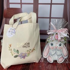 two bags that are sitting on the floor next to each other and one has a stuffed bunny in it