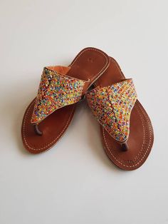 Maasai sandals made with high quality leather and colorful fine beads. Perfect for outdoor summer events , beach wear , festivals , African themed events etc. Buy multiple items and pay shipping for one item Only. Back to my shop; https://www.etsy.com/shop/TribalTess?ref=seller-platform-mcnav Beaded Toe Post Flip Flops For Festival, Multicolor Beaded Barefoot Sandals For Vacation, Traditional Multicolor Beaded Flip Flops, Multicolor Beaded Leather Flip Flops, Multicolor Leather Beaded Flip Flops, Multicolor Leather Flip Flops For Vacation, Traditional Multicolor Barefoot Sandals For Vacation, Traditional Multicolor Toe Post Sandals, Multicolor Toe Loop Sandals For Vacation