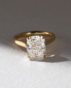 a diamond ring sitting on top of a table