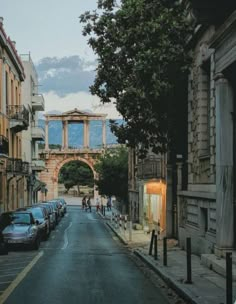 an empty street with cars parked on both sides