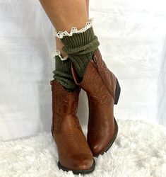 lace slouch socks for booties- olive Hottest trend for this season, mom jeans, slouch socks and crop cowgirl boots. We can't get enough of this comfy look for Fall. Olive tweed lace slouch socks for booties and cowgirl boots. You loved our slouch socks in the 90's and now they are back. Our most popular lace slouch sock. This Made in USA olive tweed knit sock is the perfect compliment to your booties and short ankle boots. Pull them up with your cowboy or combat boots, let them slouch with your Fitted Lace Trim Socks For Winter, Fitted Lace Trim Winter Socks, Fitted Green Leg Warmers For Fall, Sock Fashion, Lace Boot Socks, Short Cowboy Boots, Frilly Socks, Short Ankle Boots, Slouch Socks