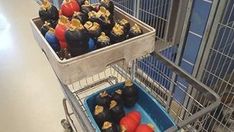 a shopping cart filled with lots of small black and red balls sitting on top of each other