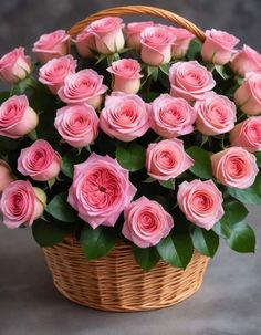 a basket filled with pink roses on top of a table