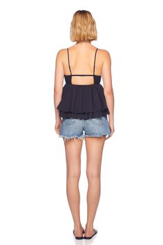 meet our cotton voile string v top, our must-have for the summer season. this top is designed from a lightweight cotton fabric making it a breeze to spend a hot day outside and forms a flattering fit with adjustable spaghetti straps. pair it with a denim bottom and sandals for the perfect beach day! deep v-neck adjustable spaghetti straps seaming below bust cutout detail at mid back layered hem 100% cotton machine wash cold, follow care instruction length 3" from the waist made in the USA model V-neck Top For Summer Outings, Chic Beach Camisole With Built-in Bra, Cotton Camisole With Built-in Bra For Vacation, Chic Cotton V-neck Halter Top, Summer Cotton Tops With Built-in Bra, Cotton V-neck Beachwear Tops, Cami Tie Back Top For Brunch, Cami Top With Tie Back For Brunch, Chic Halter Top With Spaghetti Straps For Vacation