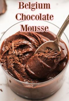 chocolate mousse in a glass bowl with a spoon on top and text overlay that reads, belgium chocolate mousse