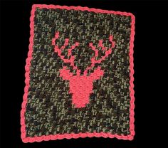 a crocheted square with a pink deer head on the front and green background