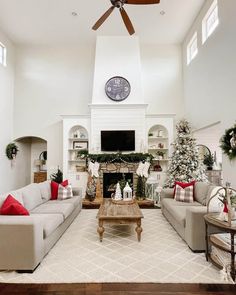 a living room filled with furniture and a christmas tree in front of a fire place