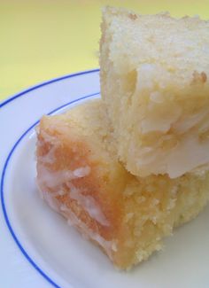 two pieces of cake sitting on top of a white plate with blue trim around the edges