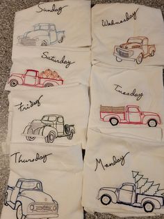 four embroidered tea towels with trucks on them