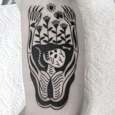 a black and white tattoo on the leg of a person with an elephant's head