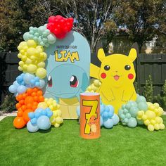 a birthday party with balloons and decorations for pikachu, eena, and pokemon