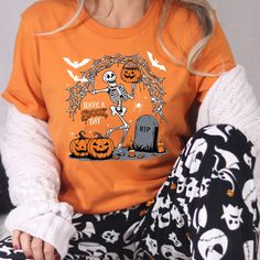 Have a spooky day t-shirt, Halloween Shirt, Witch Tshirt, Gift For Halloween, iprintasty halloween, Skeleton Fall Halloween Welcome to NoordesignBySelin!🌟 Thank you for visiting our shop! We hope you find something that adds a little extra warmth and beauty to your day. 😊 Happy Shopping! 🛒 📢 Important Details: Check All Photos: Review all images for product details. 📸 Choose Size & Color: Select your T-shirt size from the drop-down list next to the item picture. For color options, refer to Funny Halloween T-shirt With Character Print, Funny Halloween T-shirt For Streetwear, Funny Halloween Streetwear T-shirt, Fall Spooky Cartoon Print T-shirt, Spooky Cartoon Print T-shirt For Fall, Halloween Funny Print Orange T-shirt, Halloween Fun Skull Print T-shirt, Halloween Novelty T-shirt With Graphic Print, Orange Halloween T-shirt With Funny Print