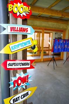 there are many signs on the pole in front of the building that says, williams keypointe superfowers pow eat cave