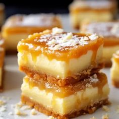 three pieces of dessert sitting on top of a white plate with powdered sugar around them