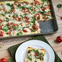 a square pizza sitting on top of a white plate