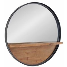 a round mirror sitting on top of a wooden shelf