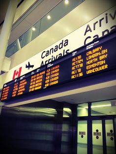 an airport sign is shown in front of the terminal entrance and information board for arrival or departure