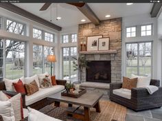 a living room filled with lots of furniture next to a fire place in a house